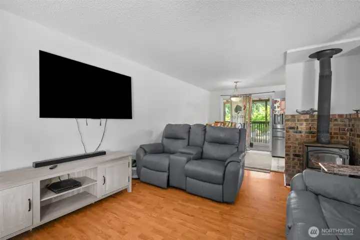 Upper-level living room with cozy wood-burning fireplace.