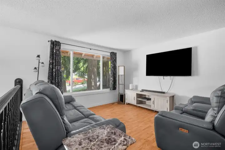 Upper-level living room with cozy wood-burning fireplace.