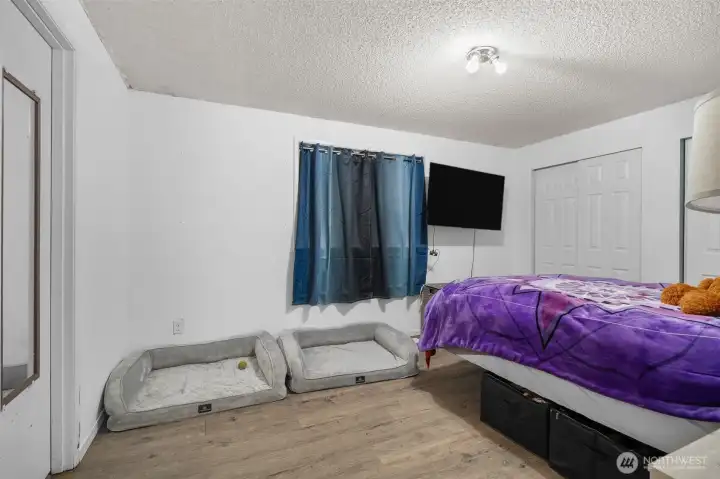 Comfortable upper-level primary bedroom featuring an  attached bathroom.