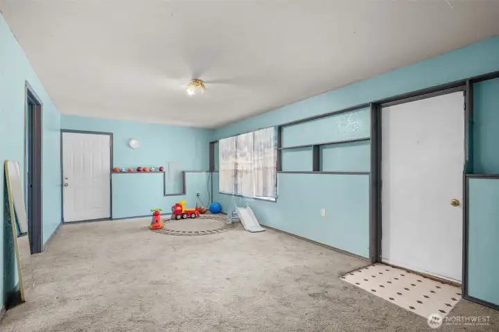 Lower-level bonus room featuring its own separate entrance—ideal for a private guest suite, playroom or home business.