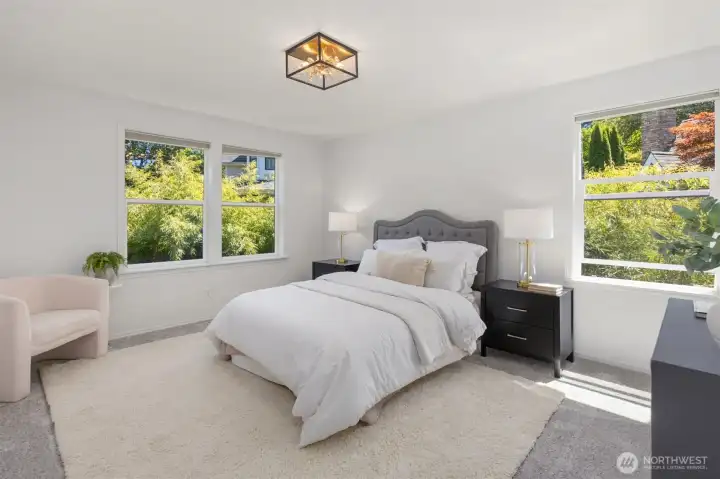 The gracious primary bedroom is flooded with natural light. The gracious primary bedroom is flooded with natural light.