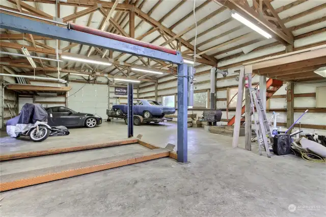 Interior view of your shop, WOW! Included car lift, compressor, large overhead doors, 2 mezzanine storage areas, 8" thick concrete floor!