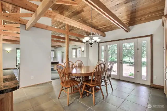 View of your dining room off the kitchen and French patio doors leading to one of your patios....and the beams! Home is just gorgeous inside and out.