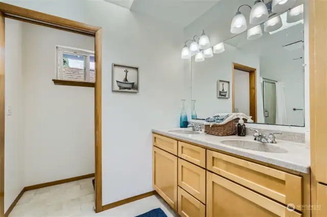 Dual corian sinks, custom bathroom built in vanity and linen closet.