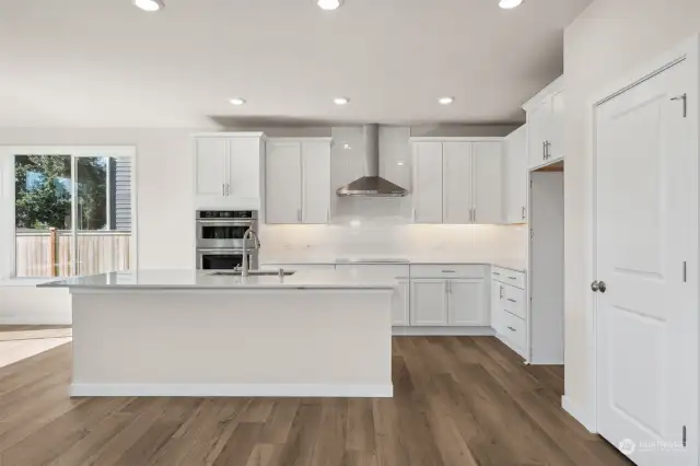 Kitchen: under counter lighting, quartz counter tops and kitchen island