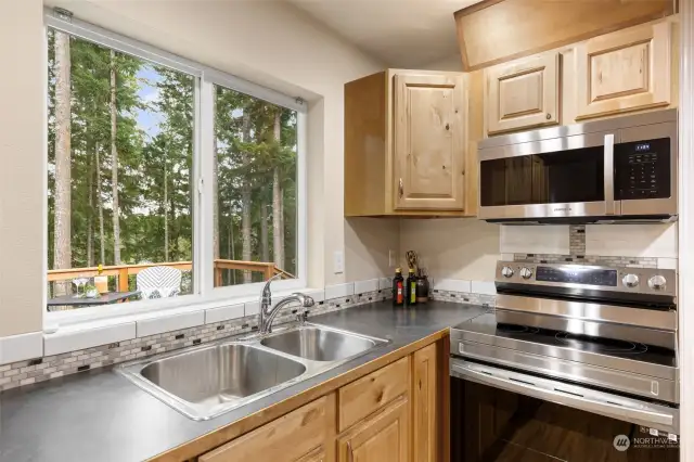 Beautiful kitchen view of the backyard and peek lake view