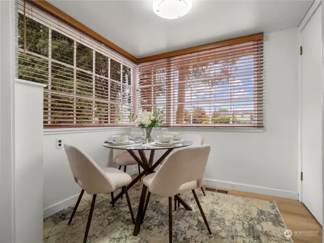 Dining nook w/built-in shelves and the door to the right leads to the basement.