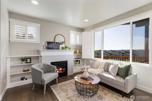 Living room with gas fireplace and built-in bookcases.