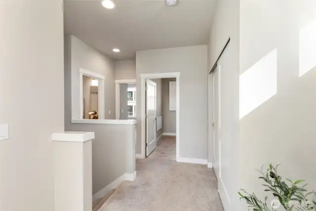 Upstairs hallway leads to laundry, 2nd bedroom, large linen closet and full bathroom.