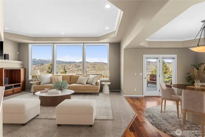 View living room and dining area with door to deck. Automatic blinds on living room windows keep home nice temperatures without taking away the spectacular views. V-stage