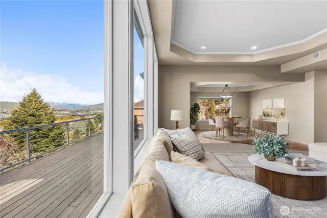 Living room looking out to expansive deck. Views of the Cascades, Mission Ridge, and your waterfall oasis below.