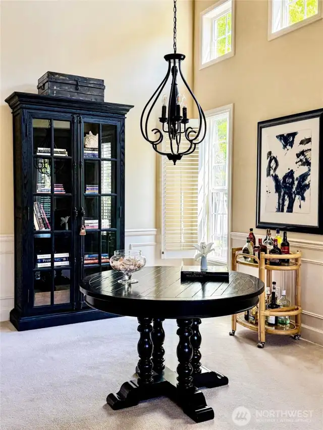 Formal dining room with soaring ceiling and new lighting fixture.