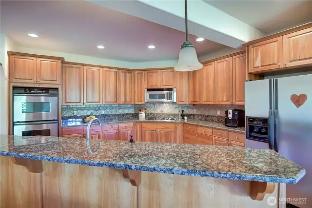 Huge kitchen with solid hardwood floor, double ovens.