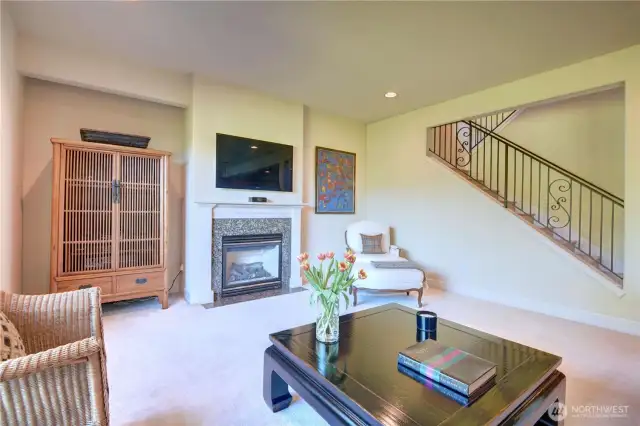 Main floor family room with a cozy gas log fireplace.