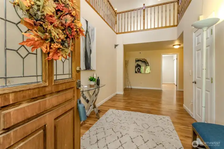 Step inside and be welcomed by a bright, open entryway that immediately sets the tone for this beautiful home. Featuring soaring ceilings, warm hardwood floors, and an elegant second-story overlook, this space feels both inviting and impressive. The natural light highlights every detail, while the spacious layout makes a perfect first impression—whether you’re greeting guests or coming home after a long day. This entryway isn’t just a hallway, it’s a statement of comfort and style!