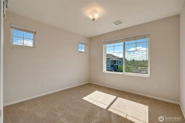 Three additional bedrooms provide flexibility for guests, home office setups, or creative spaces.