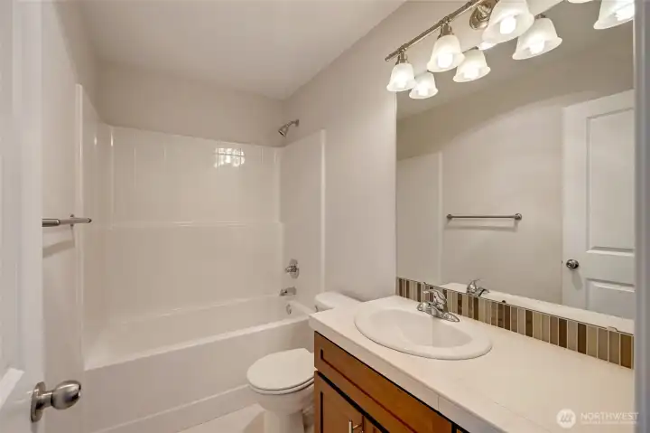 A full bathroom and upstairs laundry room across the hall add convenience to everyday living.