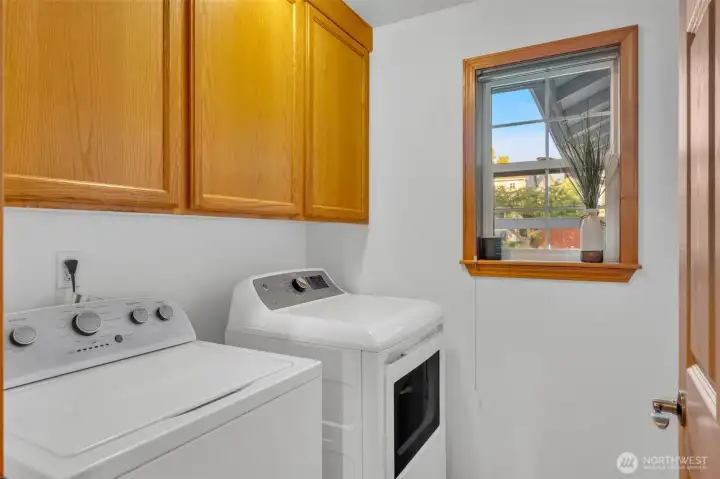 Laundry room in hallway next to bedrooms