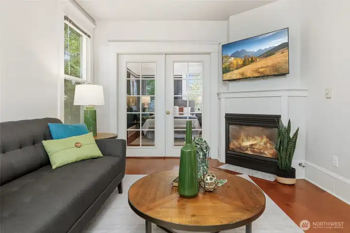 Cozy gas fireplace.  French Doors lead into the Primary Bedroom.