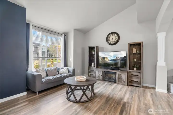 A spacious, gorgeous living room anchored by refined finishes and an open, airy feel