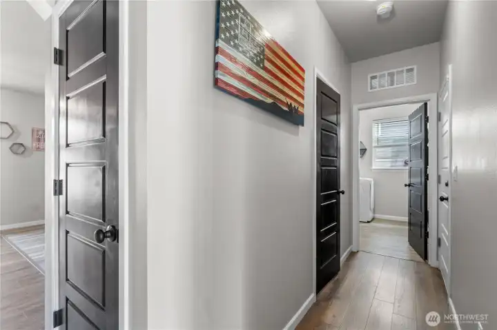 Hall off foyer leads to guest bath, laundry room and door to the fully finished garage
