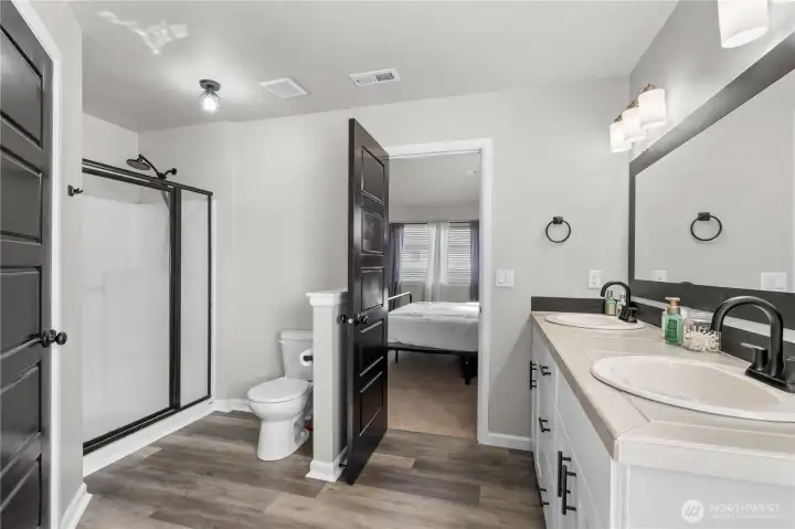 An impressive primary ensuite featuring dual sinks, a soaking tub, and a spacious walk-in closet—the perfect place to relax