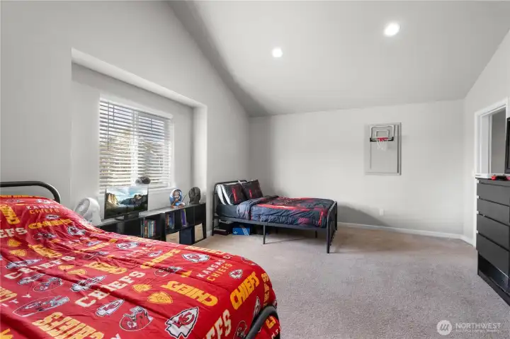 An expansive bonus room featuring soaring vaulted ceilings, offering endless possibilities for a home office, gym, or media retreat