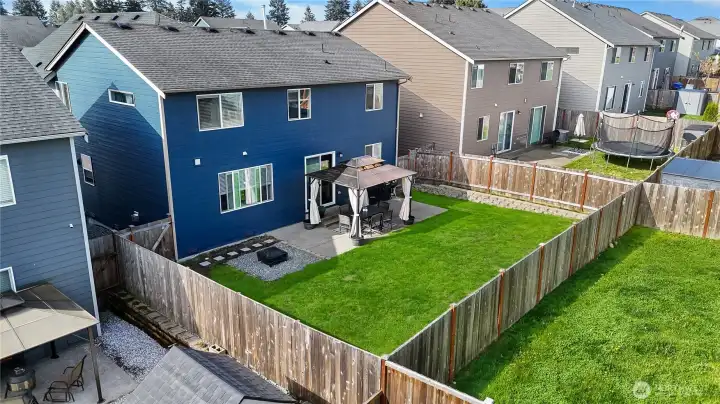 The backyard is beautifully anchored by an expanded patio and a charming gazebo, offering an ideal setting for outdoor entertaining