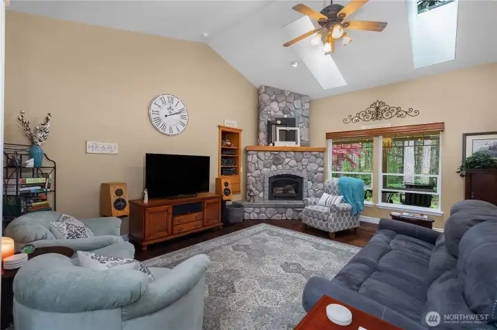 Great room with ceiling fan.  Propane fireplace.