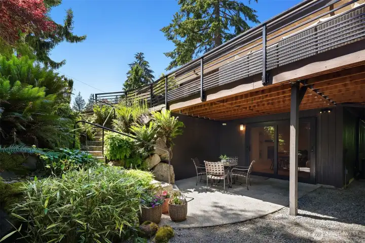 lower level patio with steps to  green belt area of property