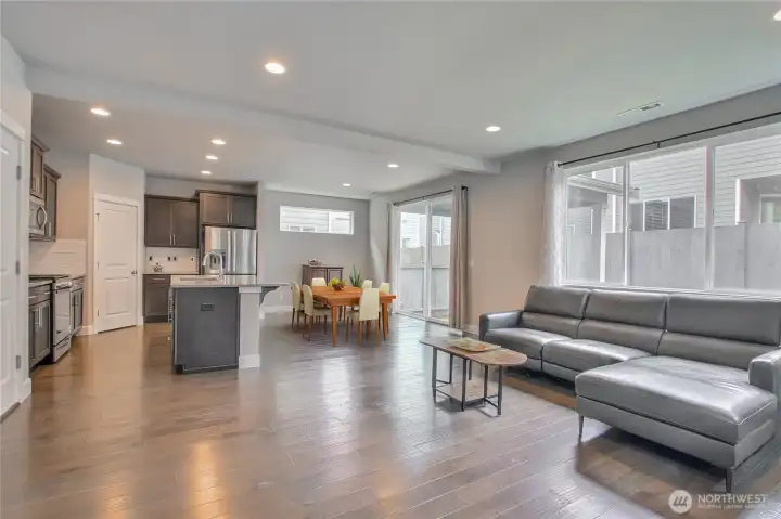 beautiful Hardwood look surface floorings throughout at Living room to dining room and kitchen area - virtually staged beautiful Hardwood look surface floorings throughout at Living room to dining room and kitchen area - virtually staged