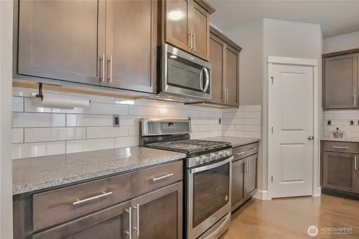 Kitchen has beautiful white glossy tile backsplash and quartz countertops Kitchen has beautiful white glossy tile backsplash and quartz countertops