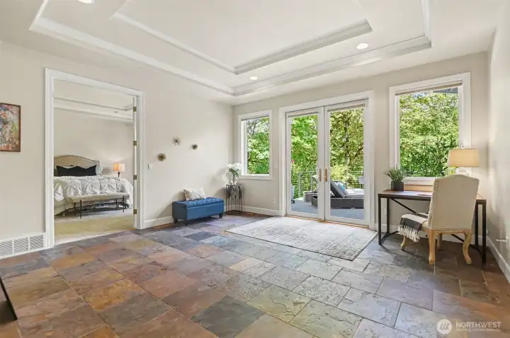 Luxurious primary suite, located in a separate wing of the house, has a sitting room with double doors to the deck and a remodeled, ADA compliant bathroom. Luxurious primary suite, located in a separate wing of the house, has a sitting room with double doors to the deck and a remodeled, ADA compliant bathroom.