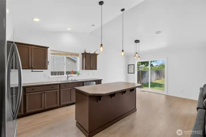 Lovely new flooring, updated lighting and stainless appliances make this kitchen sing