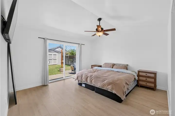 Primary suite is spacious with tall ceilings, dual walk in closets, ceiling fan and en suite bathroom