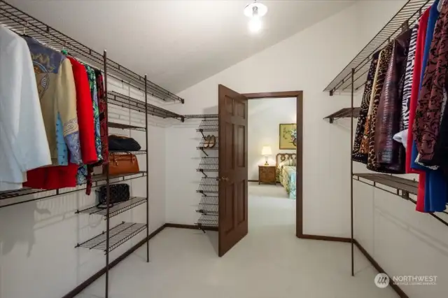 Large walk in closet with bedroom beyond