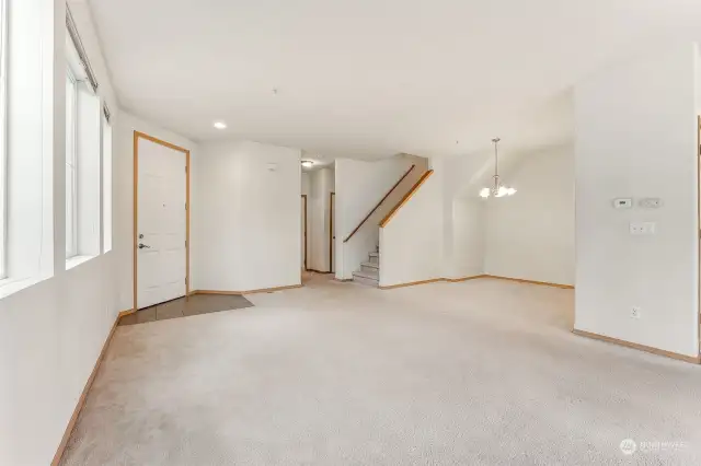 View from the family Rm to the main entrance, half bath and utility room off hallway to garage.