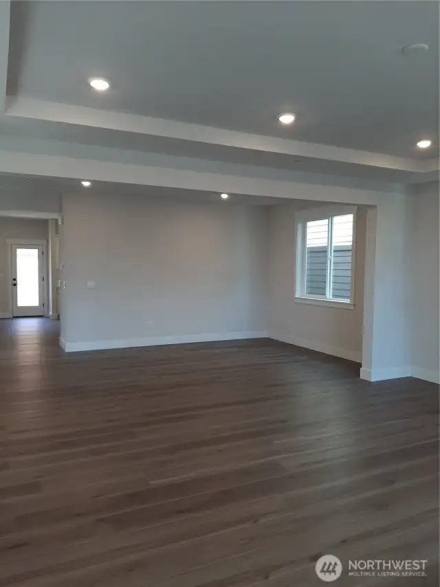 View from great room, through dining room into kitchen, highlighted by 9' ceilings.