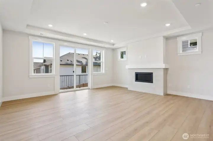 Great room with sliding door access to east facing deck. Photo is of similar home-details & finishes will vary-ask site agent for details