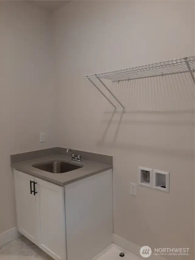 Laundry room on the second floor offers desirable utility sink.
