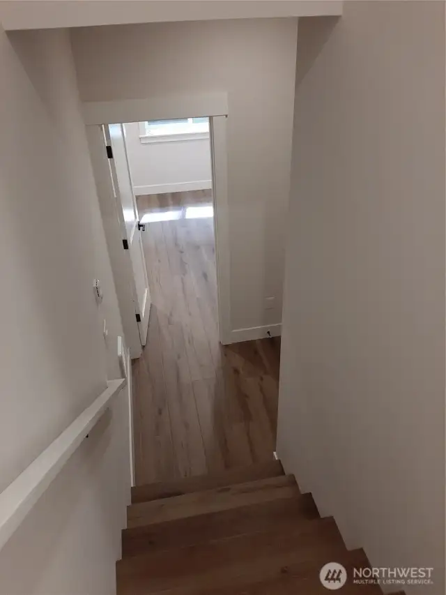 Stairway leading to light and bright lower level bedroom.