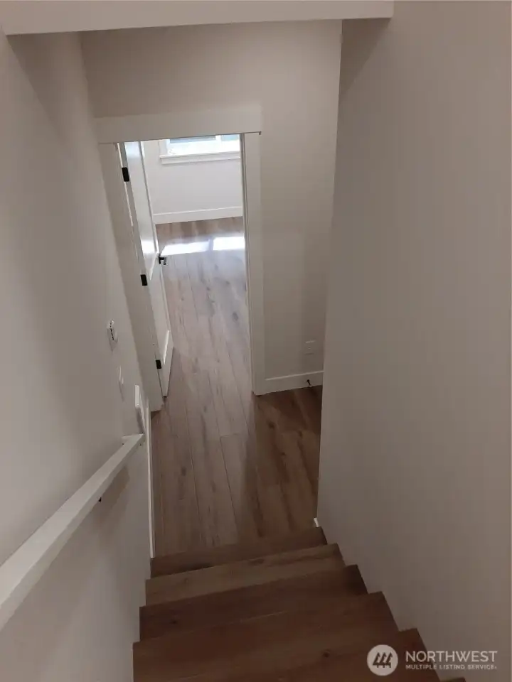 Stairway to light filled 5th bedroom on lower level.  Photo is of similar home-details & finishes will vary-ask site agent for details