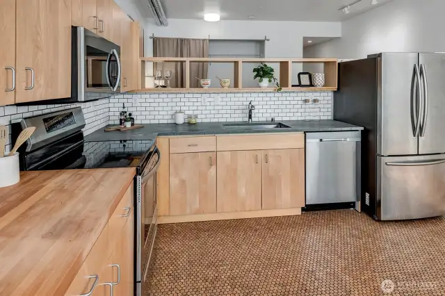 Rich maple cabinetry and stylish subway tile