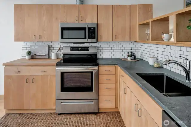 Caesarstone countertops with butcher block. Induction cooktop