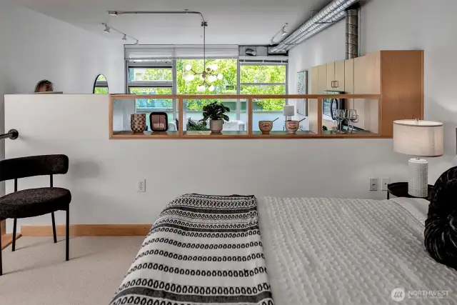 Lofted bedroom with carpet adds warmth and privacy