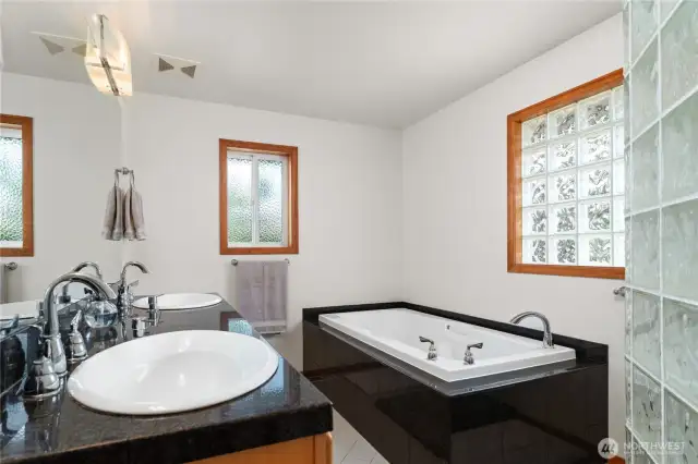 Primary bathroom with double sinks, soaking tub and large walk-in shower.