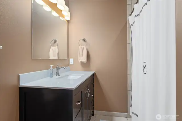 Full bathroom with tiled floors - lower level.
