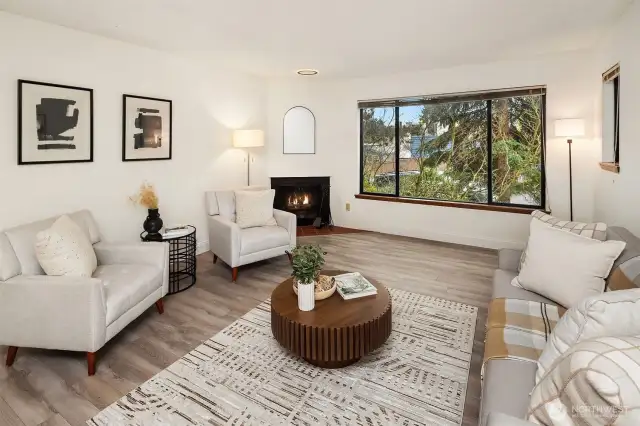 Spacious living room centered around a cozy wood-burning fireplace.
