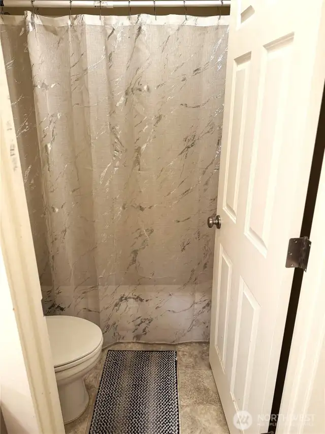 Bathroom 1 Shower and Toilet Seat entry way