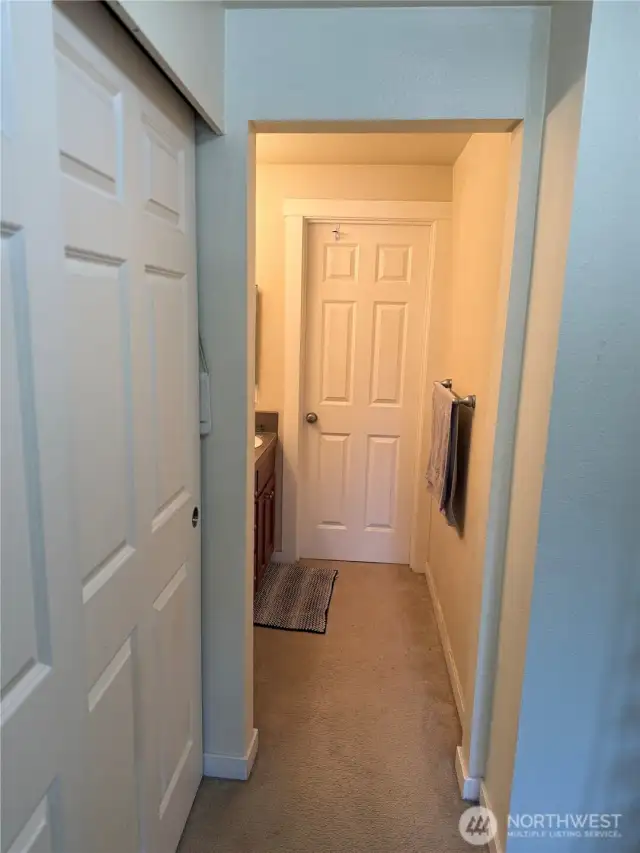 Primary bedroom closet and bathroom within the room.